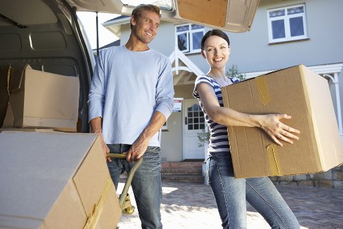 Professional movers carrying furniture during a house removal